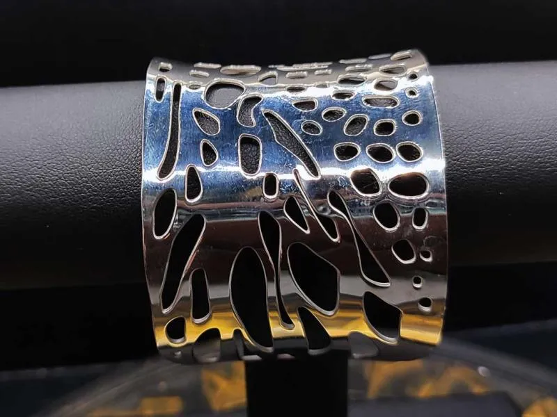 Wide women's bangle with hole pattern made of stainless steel