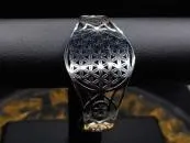 Curved women's bangle with flower of life made of stainless steel